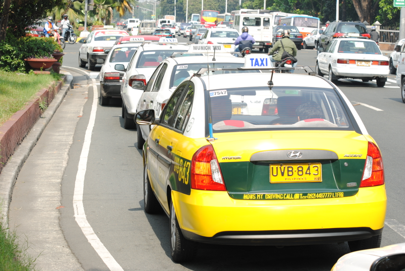 An Accent sedan taxi in the Philippines - note the amber turn signals and black plastic logo plate.